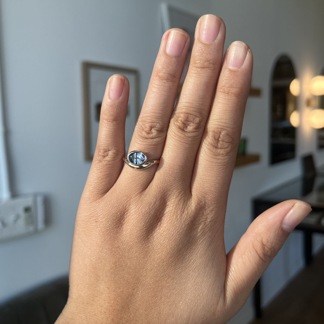 Blue Oval Sapphire Nestled Ring
